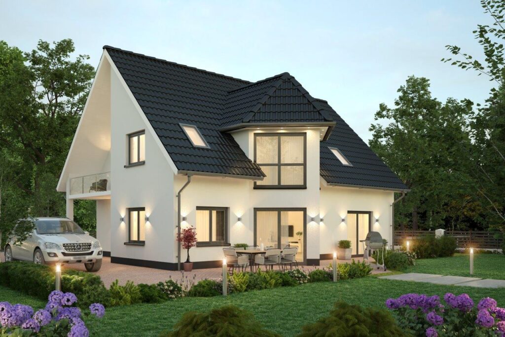 Das Bild zeigt ein modernes Zweifamilienhaus mit großen Fensterfronten von Generalunternehmer Wilms AG. Möchten Sie auch ein Haus für 2 Familien bauen in Berlin und Brandenburg? Dann helfen wir Ihnen gern weiter.